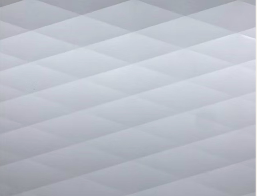 Diamond pattern aluminum siding — diagonal embossed diamonds in white enamel